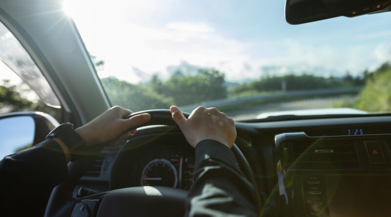 People driving car on sunrise mountain road